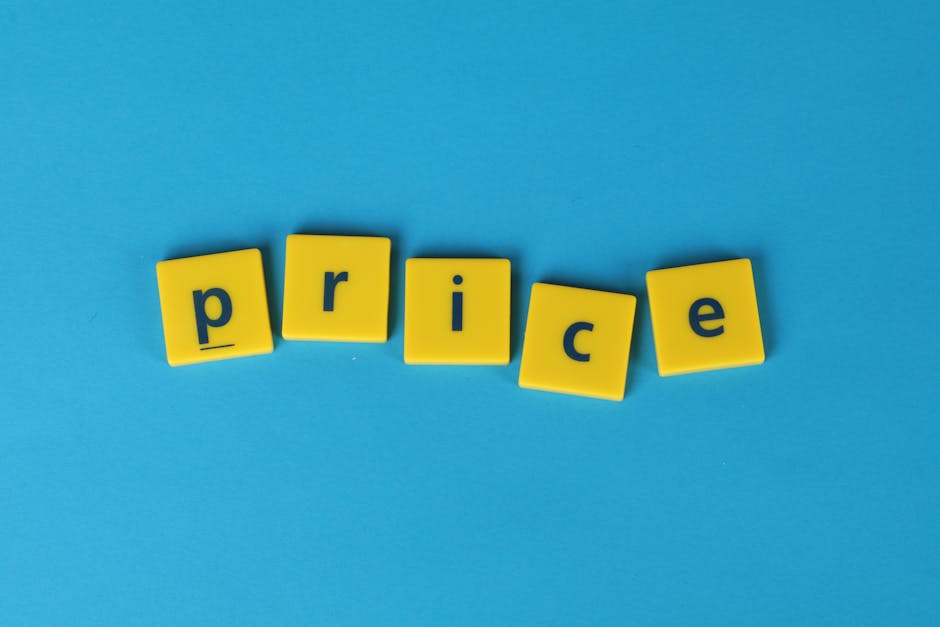Several yellow plastic letter blocks spell out the word 'price' on a solid light blue background. The blocks are arranged in a slightly curved line with some leaning to the side, with each block displ